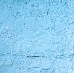 A blue wall with a rough texture
