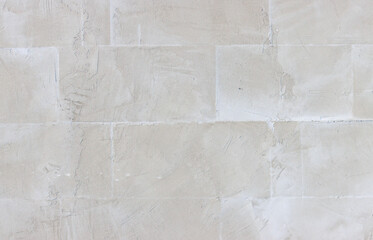 A wall with a white background and a grey brick pattern