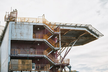 Yellow railings on multi-level industrial building exterior
