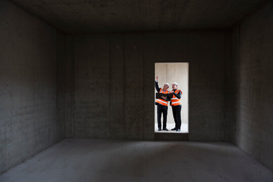 Engineers inspecting a shell construction site indoors