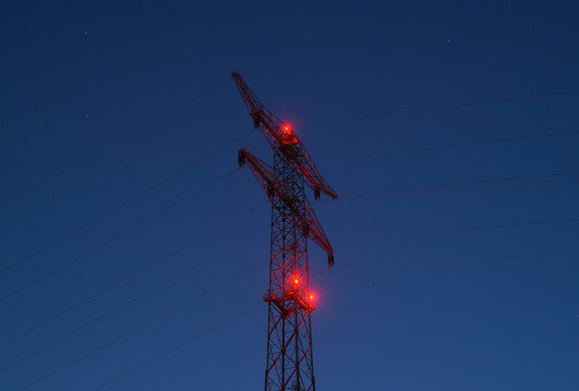 Power line with red lights at dusk in the Netherlands