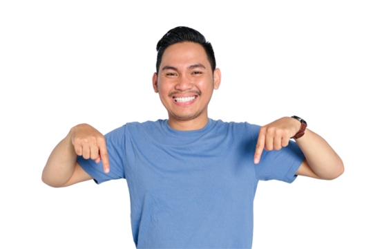 Happy young Asian man smiling and pointing downward with both hands, wearing casual blue t-shirt, isolated on transparent background