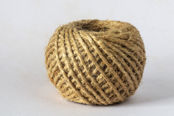 A ball of jute twine on a white background.