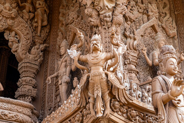 Fototapeta premium The intricate wooden architecture of the Temple of Truth in Pattaya,Thailand.The temple features ornate carving and statues,with a detailed root structure and multiple spires.outside view
