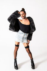 Smiling Non-Binary Person Poses Confidently in Stylish Outfit With a Bold Fashion Statement