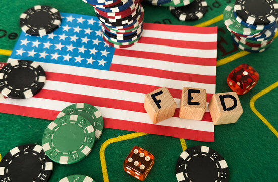 The Federal Reserve ( FED ) to control interest rates. Gold text FED on USA flag background. American economy and business. Federal Reserve Bank Interest rates rise policy. World economy crisis.