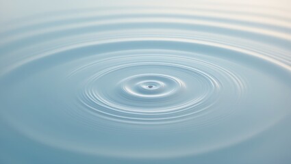 Circles on the surface of water against a pale blue backdrop.