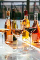 Different types of wine in glasses - red, white, rose and amber. Wine tasting in a bar or restaurant.