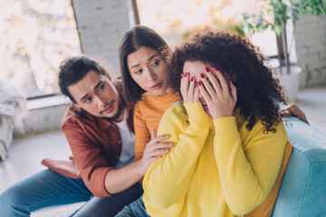 Concerned friends provide comfort to a woman in an emotional moment, highlighting themes of friendship