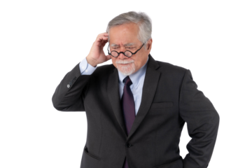 A confused senior Asian businessman in a dark suit, scratching his head and wearing glasses, standing against isolated on a transparent background, projecting a sense of puzzlement and contemplation