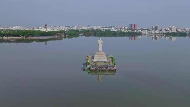 buddha statue, ambedkar statue with buildings reflections on hussain sagar lake at tank bund, Khairtabad, hyderabad, telangana, india. day time, moving down, drone shot, 4k.