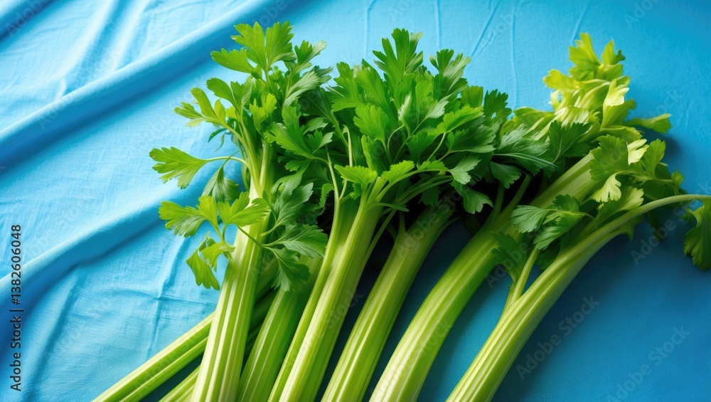 Poster fresh celery placed on a blue table background with blank space for text, emphasizing its antioxidan