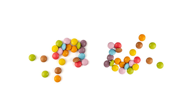 Scattered small candies isolated. Colorful dragees, multicolored glazed chocolate buttons