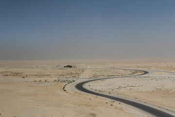 Desert scenery with the highway on the road trip from Hurghada to Cairo, Egypt
