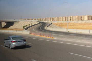 Grey car on the highway and New Administrative Capital on the road trip from Hurghada to Cairo,...