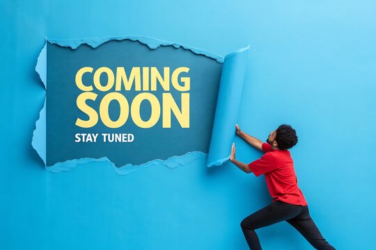 A young man reveals a Coming Soon message creating anticipation and excitement with a vibrant blue background and bold text stay tuned for what s next