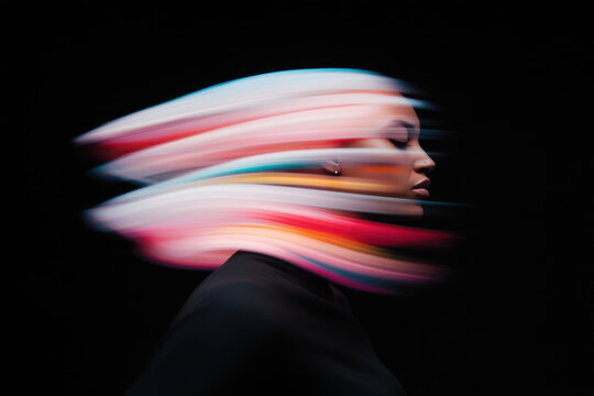 Woman with colorful blurred lines moving across face
