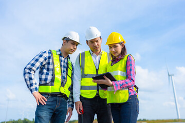 Wind energy engineers from the renewable industry discussing project metrics and business...