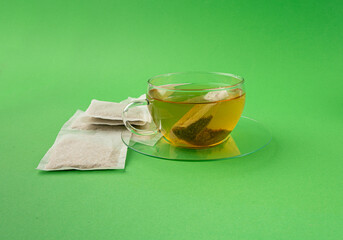 Herbal tea sachet in cup, hot water with chamomile and Hypericum or St. John's wort teabag