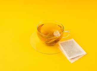Herbal tea sachet in cup, hot water with chamomile and Hypericum or St. John's wort teabag
