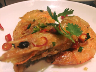 Thai Chinese food - Shrimps fried with chilies garlic and salt on white plate