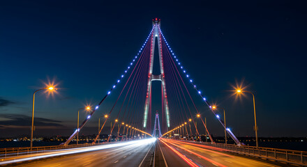 Obraz premium Cable-stayed bridge with blue lighting at night