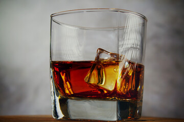 A glass of whiskey with ice. A strong alcoholic drink