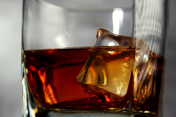 A glass of whiskey with ice. A strong alcoholic drink