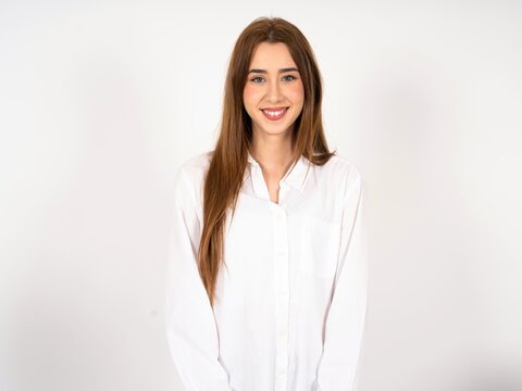 Close up photo of Caucasian young girl wearing white shirt toothy smiling