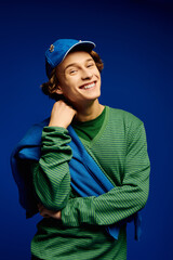 Fashionable young man showcases modern style against a vibrant backdrop capturing youth culture