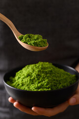 Wolffia or watermeal in bowl and spoon holding by hand, Healthy edible small aquatic plant high protein and fiber