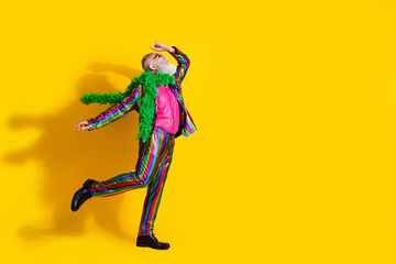 Photo of positive pensioner charismatic showman wear stylish striped bright outfit suit dance isolated on yellow color background