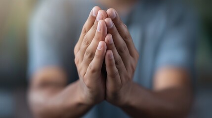 Hands in gesture of prayer or request with blurred background