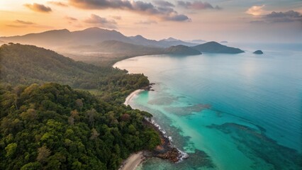 Fototapeta premium Koh Chang Beach Island Satun Thailand Aerial view of a serene coastline with lush green hills and clear turquoise waters at sunset.