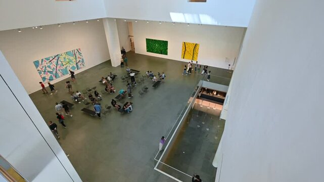 New York City, USA, August 20, 2024. Top view of people walking in the visitor hall of MoMA, Museum of Modern Art.