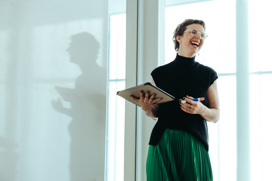 Fototapeta Non-binary businessperson presenting with whiteboard