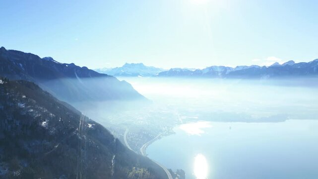 Orbit drone shot of landscape from Caux Palace Hotel of Lake Geneva and Dents du Midi mountain range in Caux, canton of Vaud, Switzerland