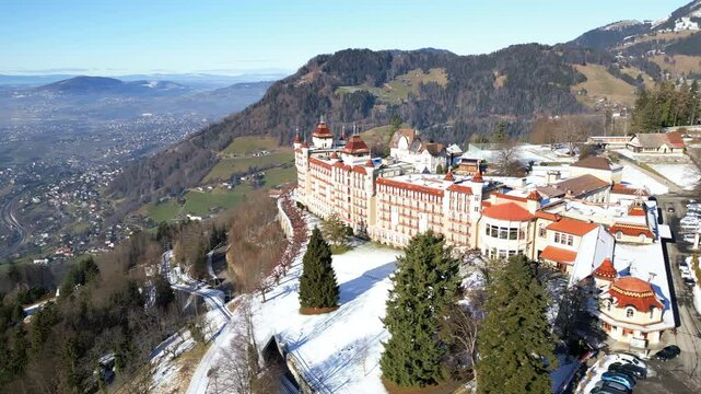 Aerial: Caux Palace Hotel during the day in the village of Caux, canton of Vaud, Switzerland, orbit drone shot