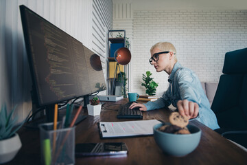 Young professional woman working on programming tasks in a modern home office setting
