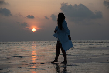  Woman Walking on Beach at Sunset Silhouette Scene
