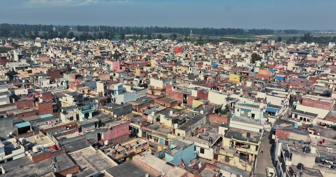 Aerial view of an Indian City and agricultural fields near the Delhi-Chandigarh Highway in Punjab, India. Natural texture for the background. The picturesque countryside of India. Healthy food concept