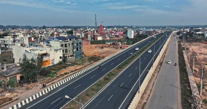 Aerial view of an Indian City and agricultural fields near the Delhi-Chandigarh Highway in Punjab, India. Natural texture for the background. The picturesque countryside of India. Healthy food concept