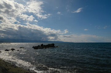 Breathtaking coastal view on a sunny day with clouds rolling in over tranquil waters