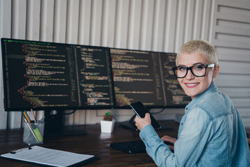 Professional young programmer working on computer coding in stylish office environment