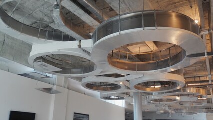 Circular metal lights hanging from ceiling, showcasing industrial aesthetic.