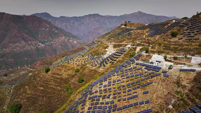 Aerial view of multiple solar panel installations in remote hills of Uttarakhand, Generating Power through solar roof and developing the India concept