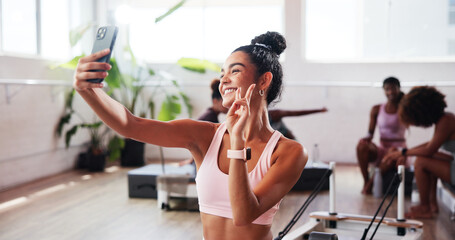 Girl, selfie and peace sign at gym for fitness, happy and icon for post results on social media. Influencer, woman and gesture with smile, symbol or profile picture with healthy body exercise club