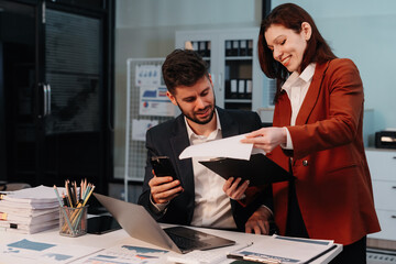 Business team working on a project in the office or reviewing and discussing a business project.