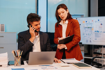 Business team working on a project in the office or reviewing and discussing a business project.