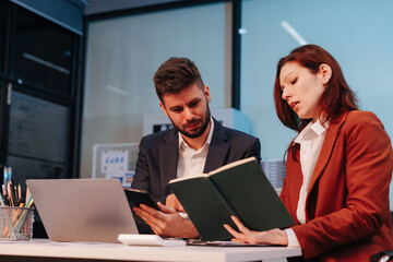 Business team working on a project in the office or reviewing and discussing a business project.